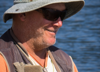 Chris Cleaver with his recently caught and released hybrid cod he likes to call a Murrout (cross between a Murray and trout cod).